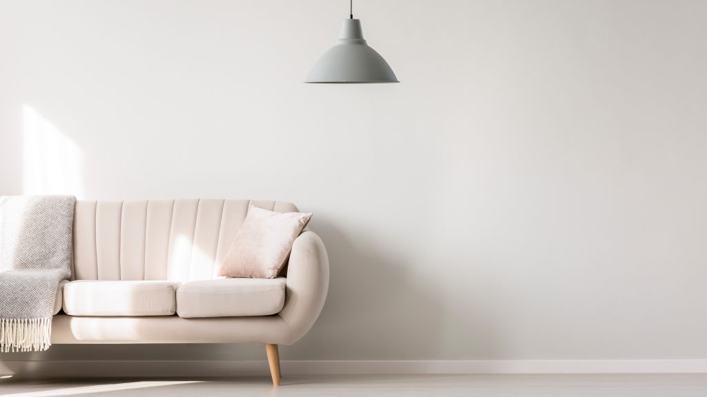 Beige,Sofa,Against,White,,Empty,Wall,With,Copy,Space,In