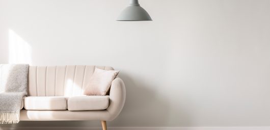 Beige,Sofa,Against,White,,Empty,Wall,With,Copy,Space,In